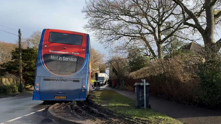 Bus stuck in mud in the middle of multi-way temporary traffic lights